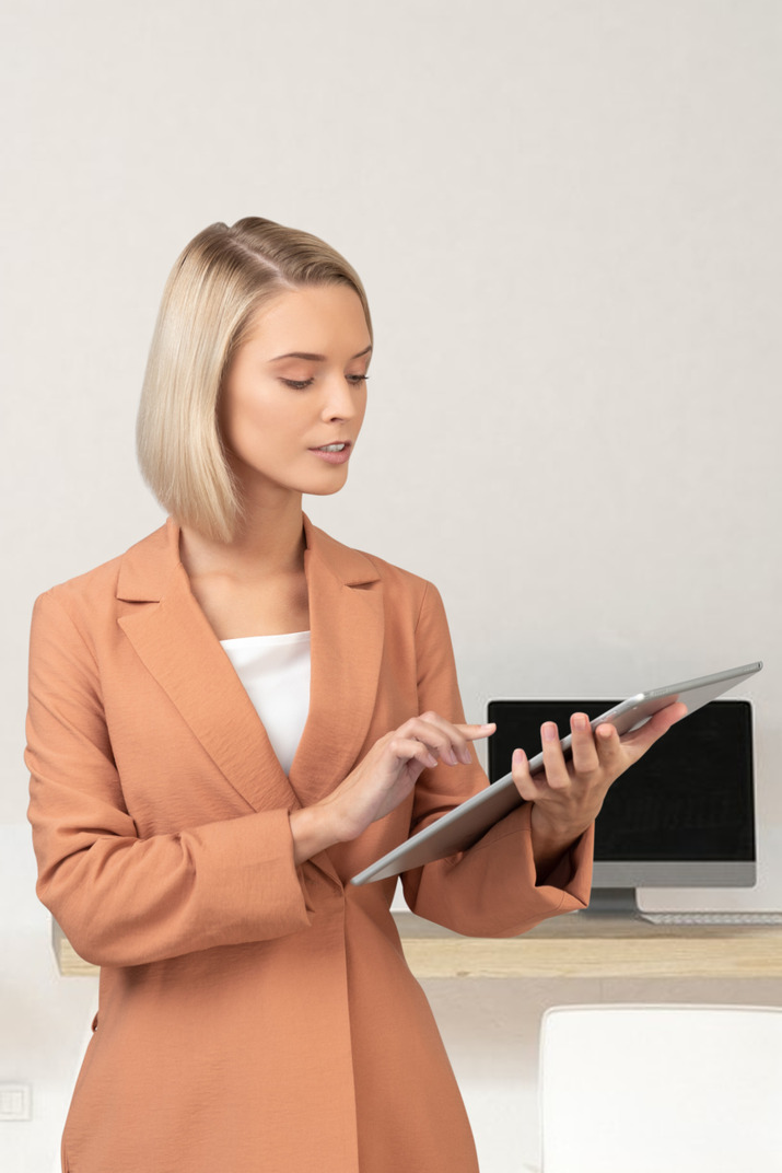 Young woman in a business suit with a laptop