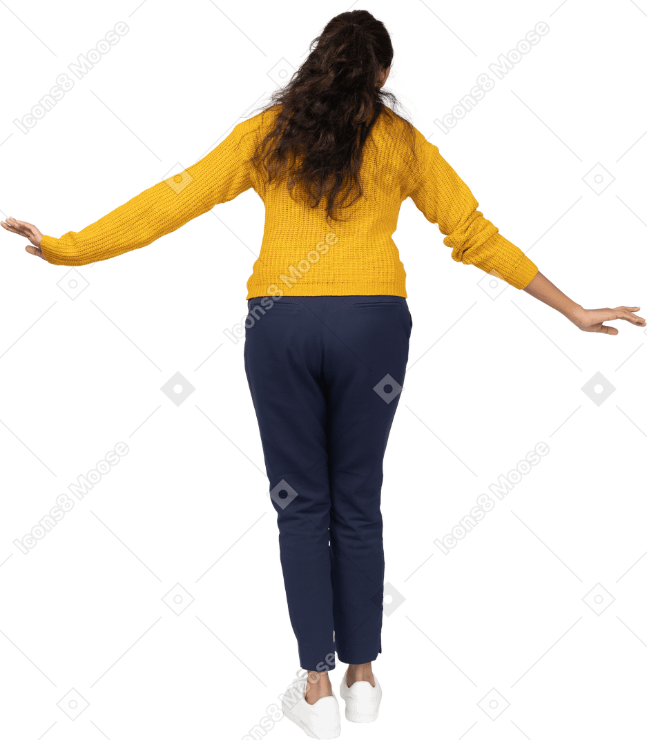 Rear view of a girl in casual clothes posing with outstretched arms
