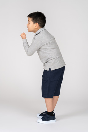 Boy showing fist in profile