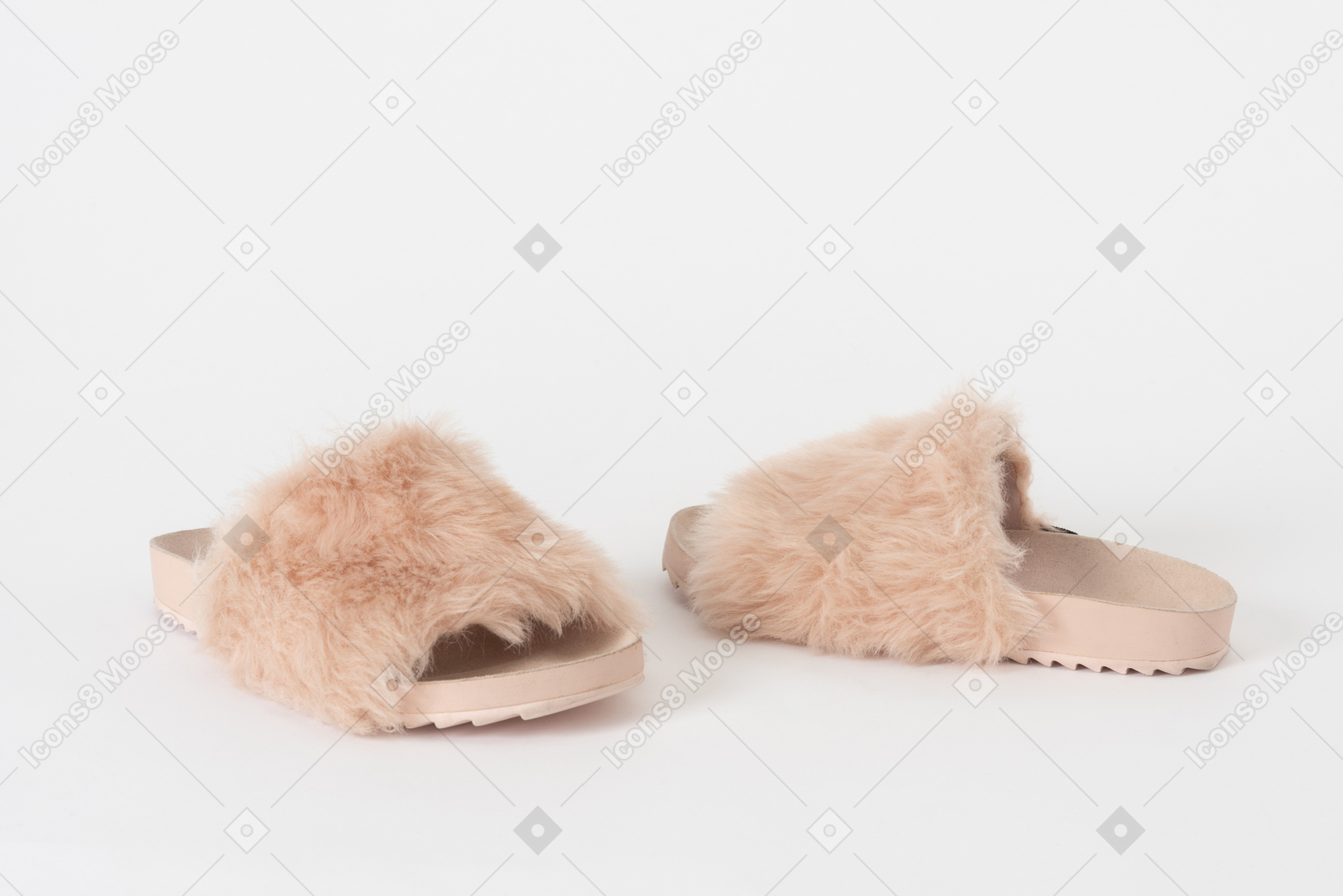 A shot of a pair of pink fluffy slippers left in  hurry
