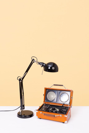 Black desk lamp and orange vintage radio