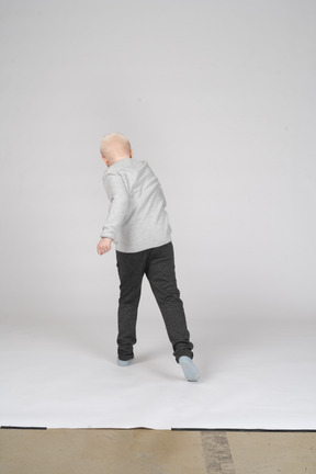 Back view of boy walking away from camera