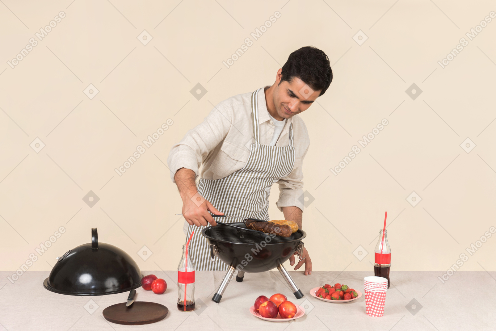 Jeune homme caucasien prépare un barbecue