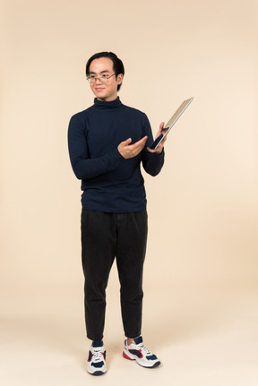 Young asian man presenting a digital tablet