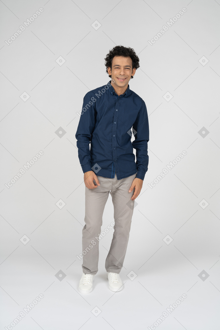 Front view of a happy man in casual clothes looking at camera