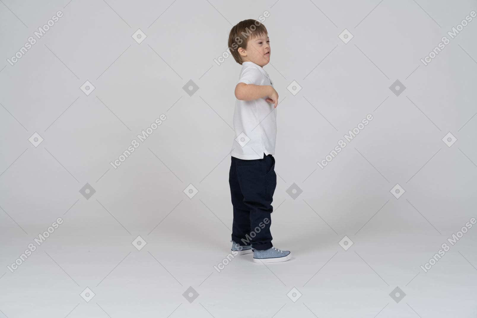 Little boy standing with his hands at his chest