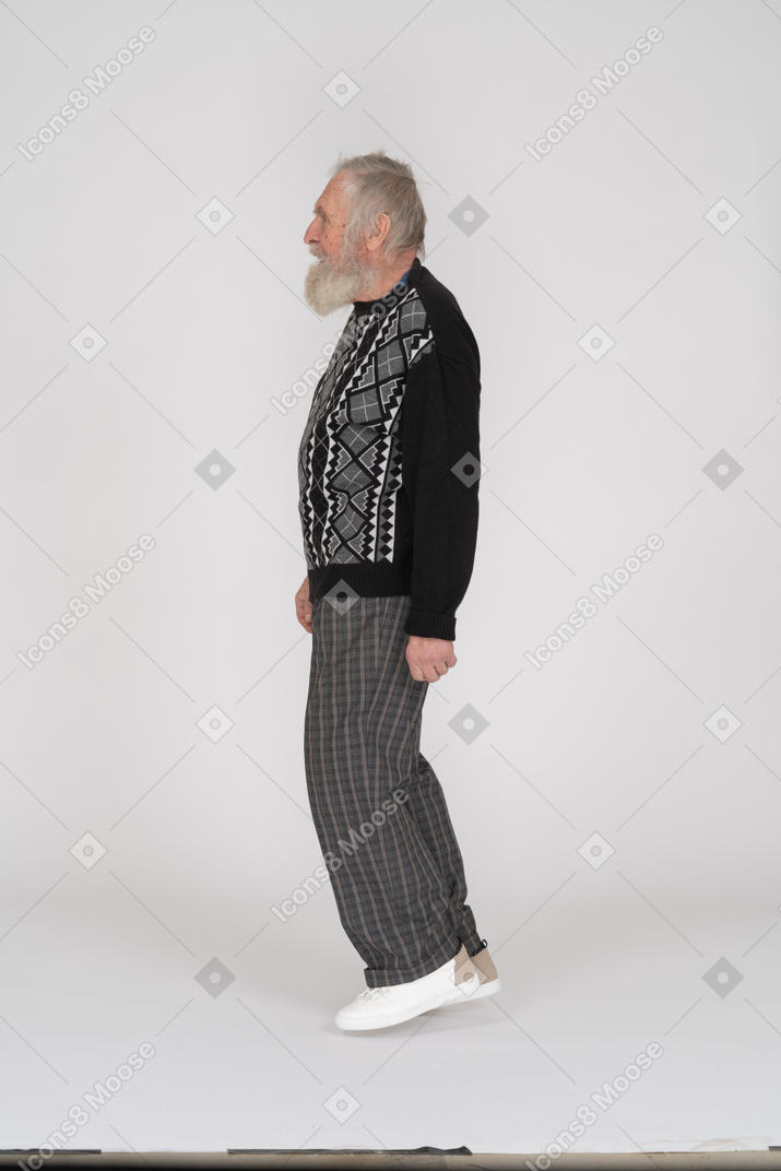 Side view of an elderly man walking