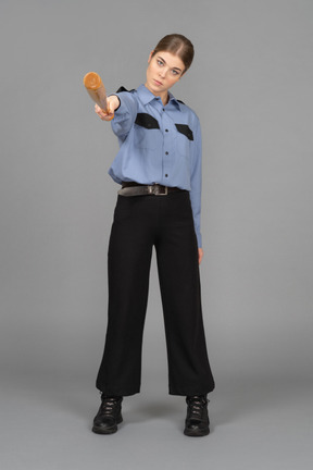 Female security guard pointing with a baseball bat