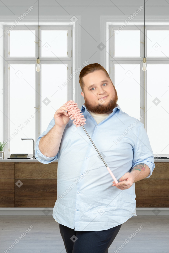 A man holding a cleaning brush
