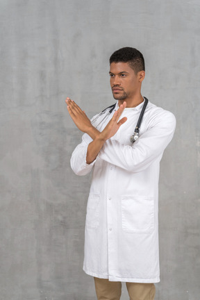 Male doctor making a stop gesture