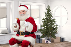 Santa sitting near a christmas tree
