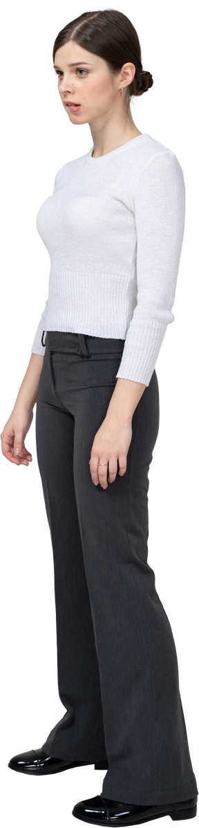 Three-quarter view of a young woman in office clothing biting lips