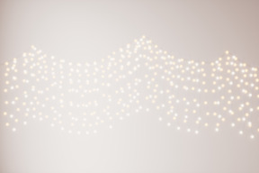 Blurred fairy lights on a white wall