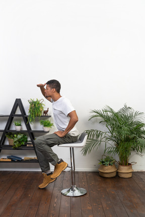 Good looking young man sitting on a chair