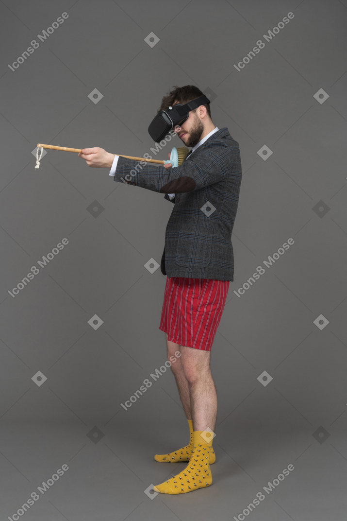 Man in vr headset with a fake rifle