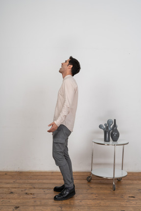 Side view of a man in casual clothes shouting