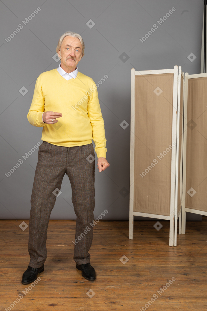 Front view of a thoughtful gesticulating old man