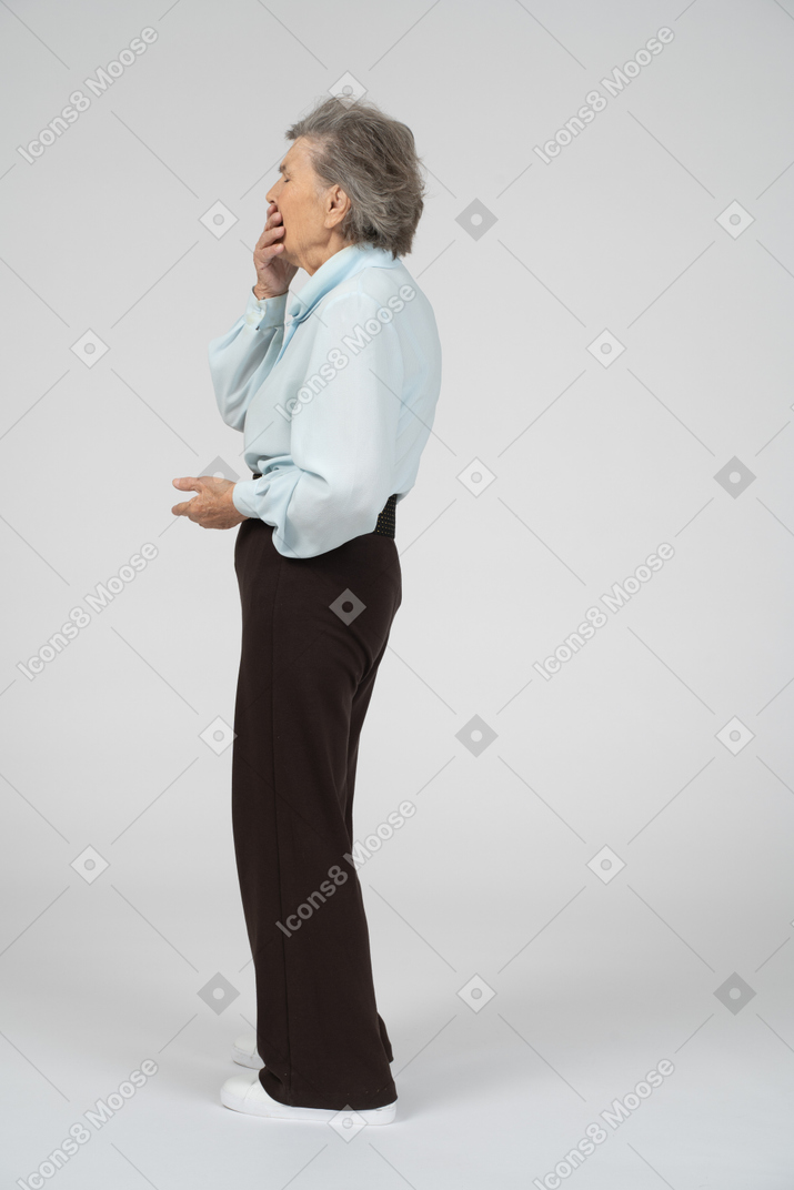 Side view of an old woman covering her mouth