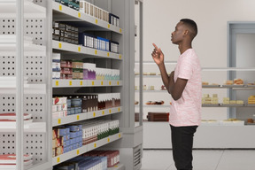 A man standing in front of a shelf of products