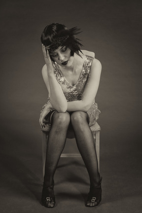 Black and white portrait of a cheerless vintage style female