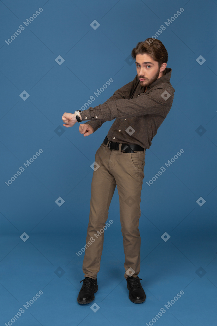 A dancing slim young man looks to camera