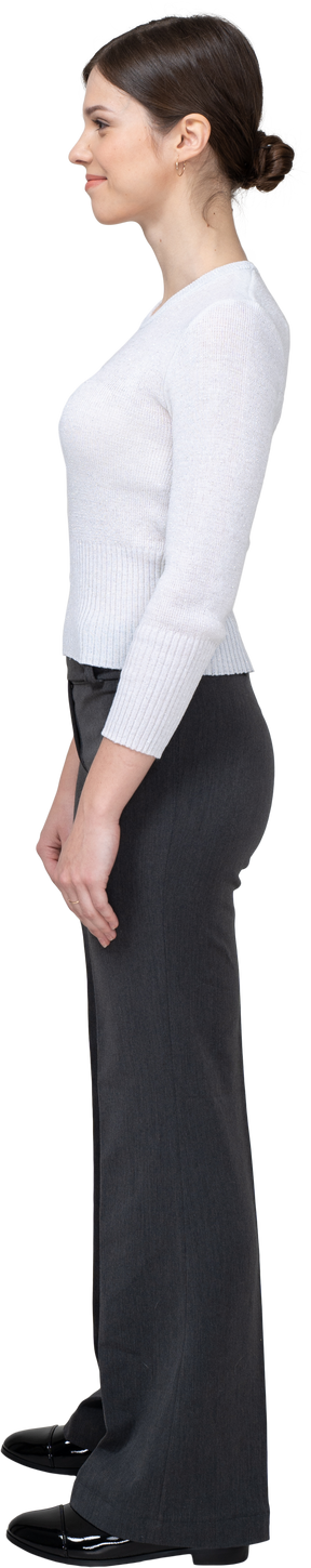 Side view of a pleased young woman in office clothing