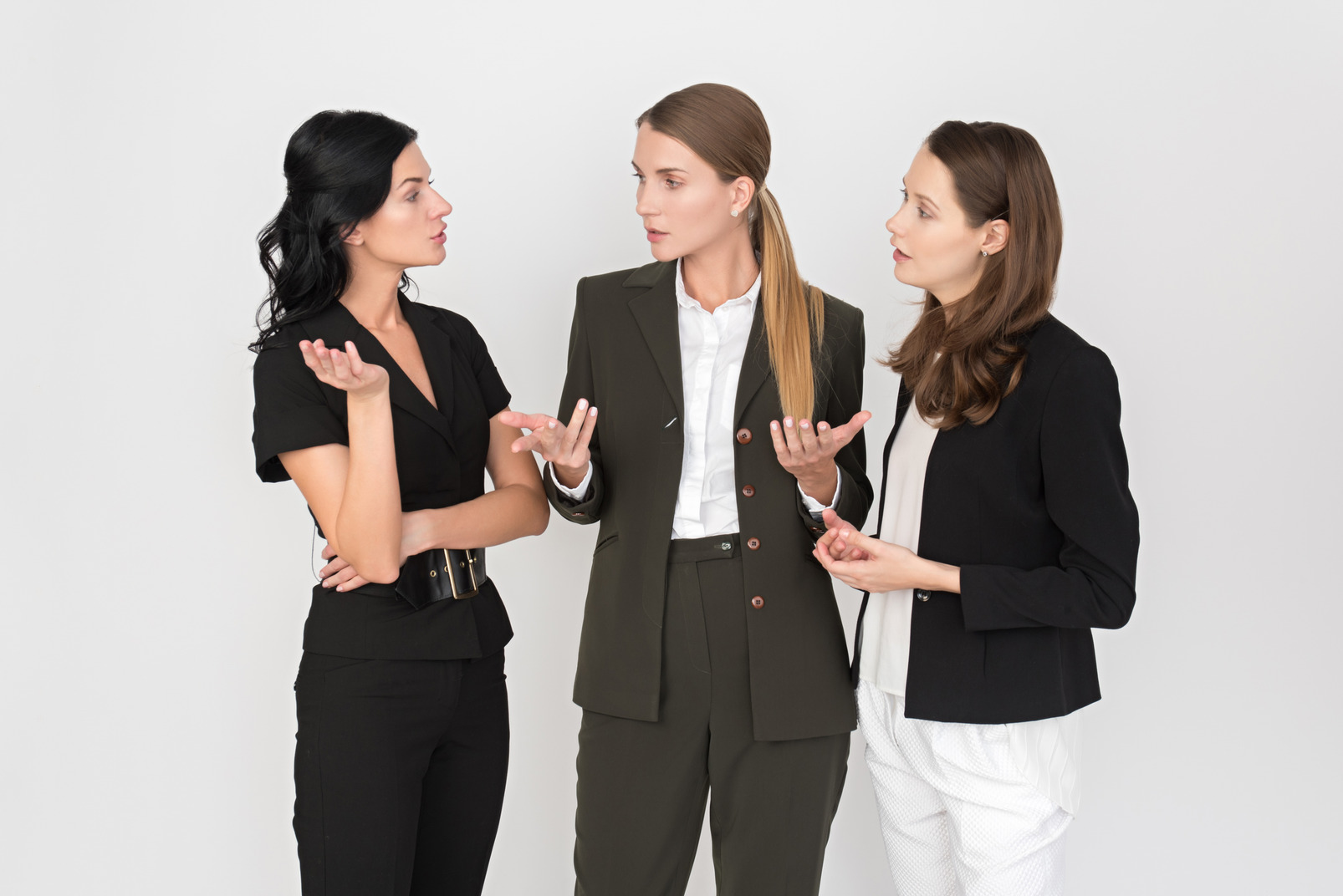 Three female office workers talking about something