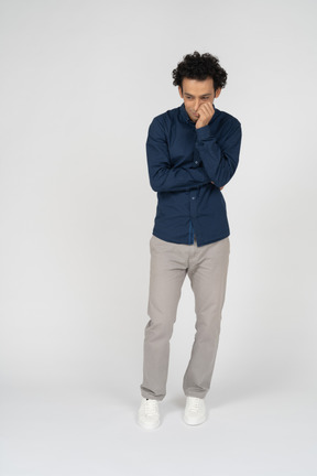 Front view of a man in casual clothes thinking