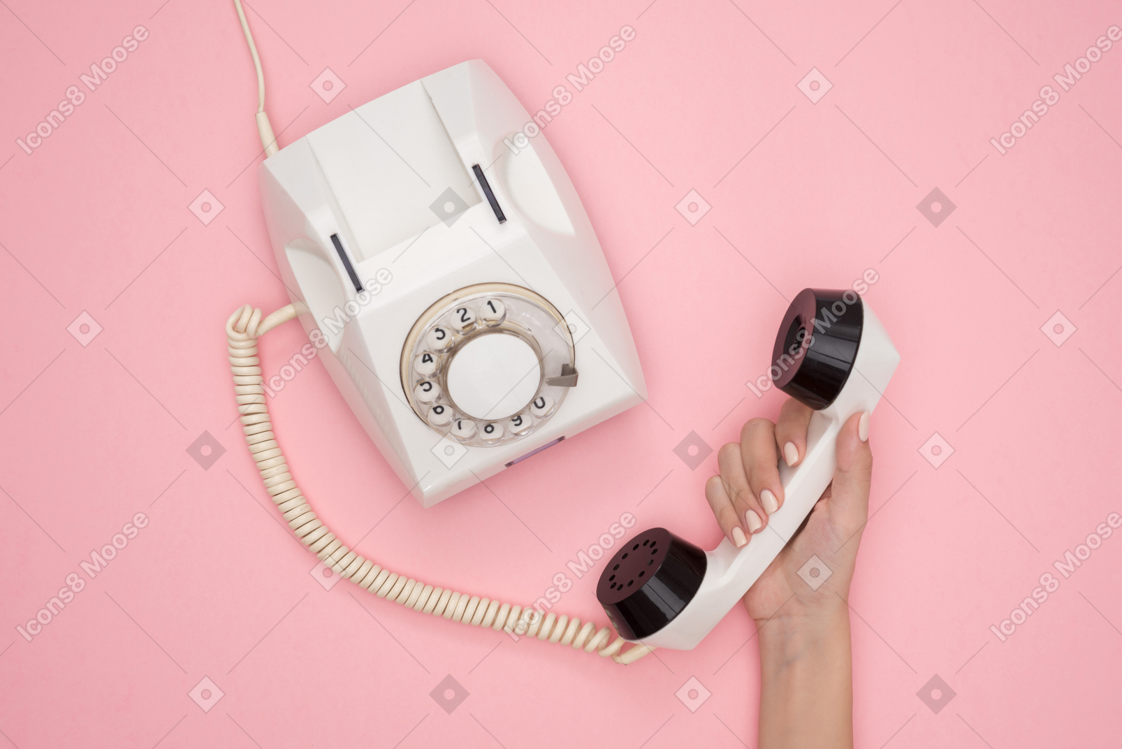 Female hand holding vintage phone receiver