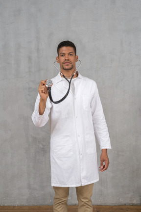 Male doctor using a stethoscope