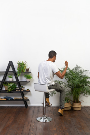 Good looking young man sitting on a chair