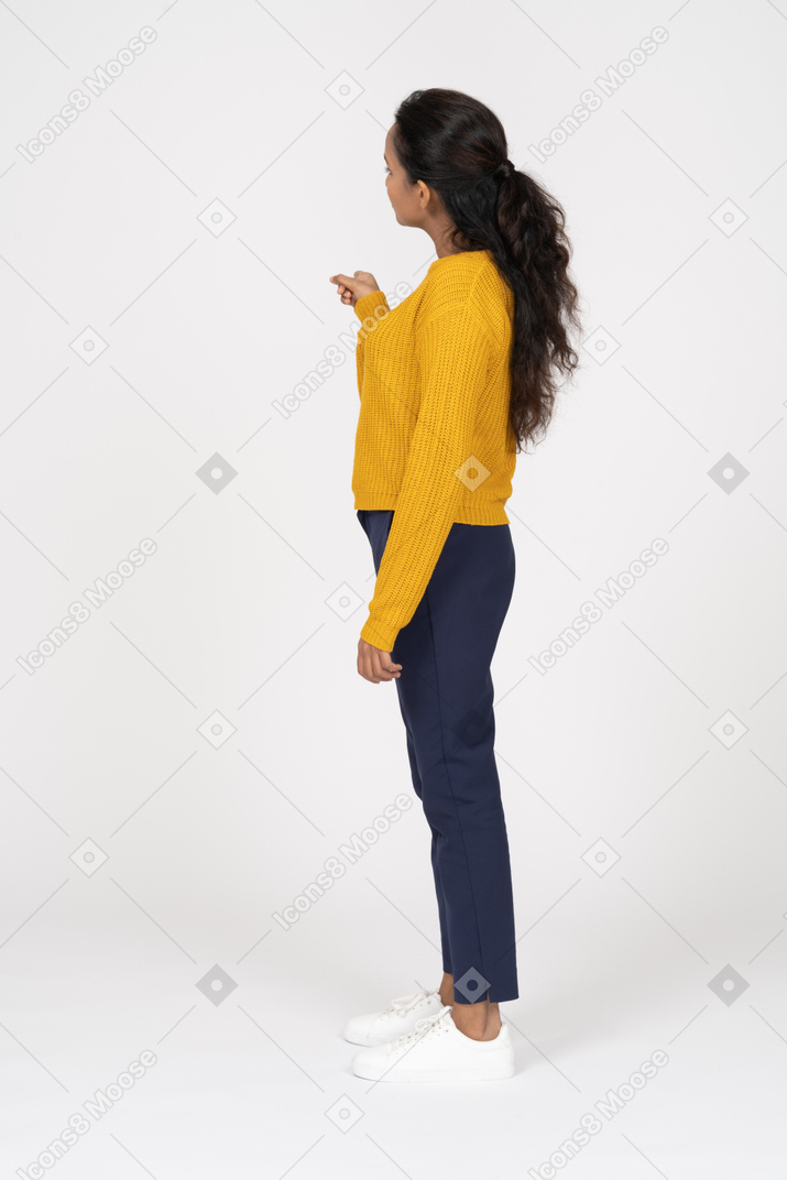 Side view of an interested girl in casual clothes looking aside