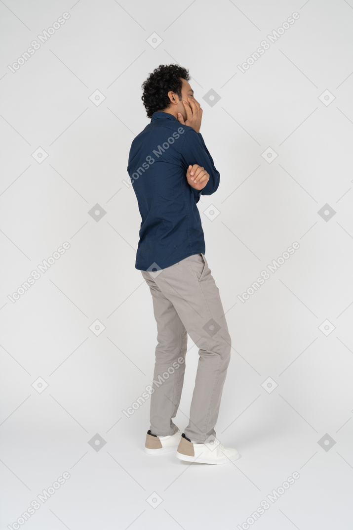 Side view of a man in casual clothes thinking about something