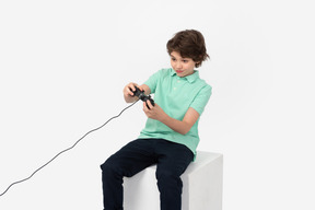 Cute boy playing video game