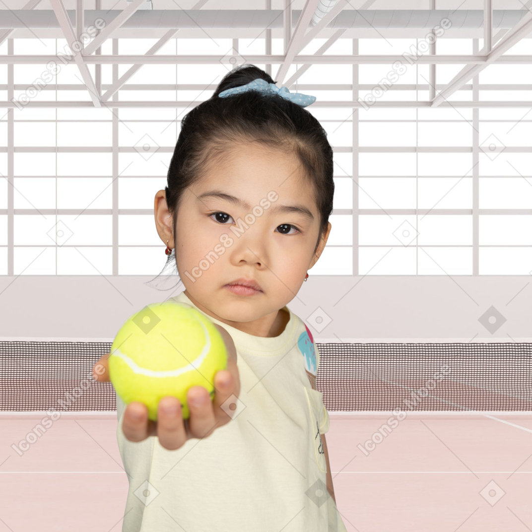 Boy playing with a tennis ball