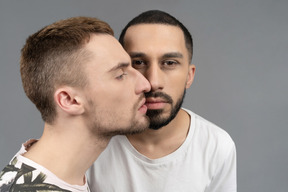 Portrait of two men looking at camera and looking aside each