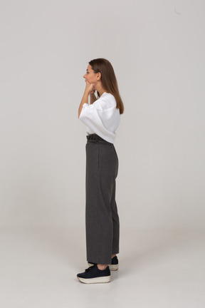 Side view of a grimacing young lady in office clothing