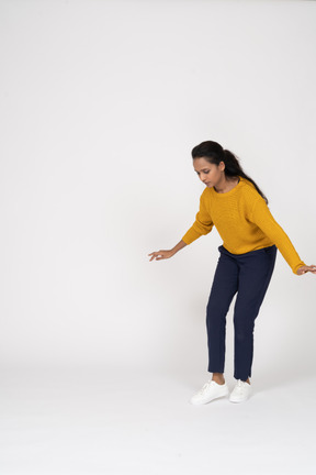 Front view of a girl in casual clothes posing with outstretched arms