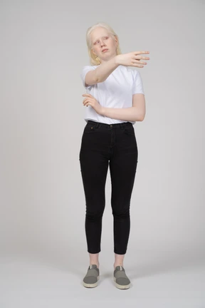 Front view of a woman raising her arm