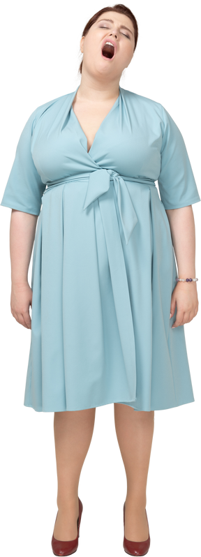 Front view of a woman in blue dress yawning