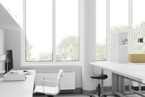 Empty science laboratory with white desks and computer monitor