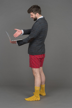 Man pointing to laptop screen with his hand