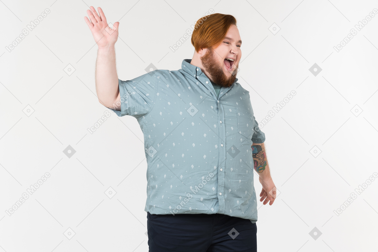 A plump man standing with his hands on his hips and laughing