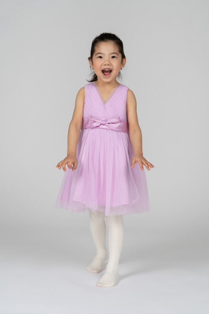 Little girl in a tutu dress posing playfully