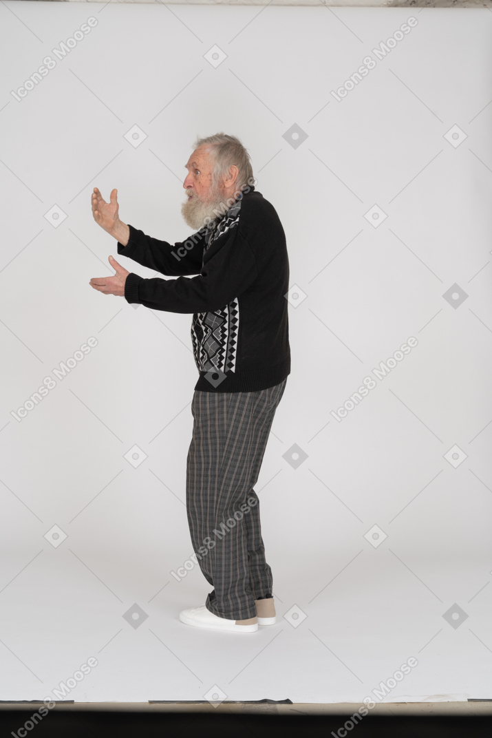 Side view of old man gesticulating