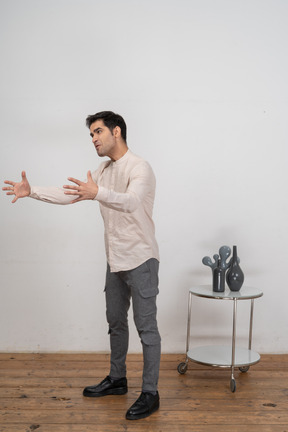 Side view of a man in casual clothes gesturing