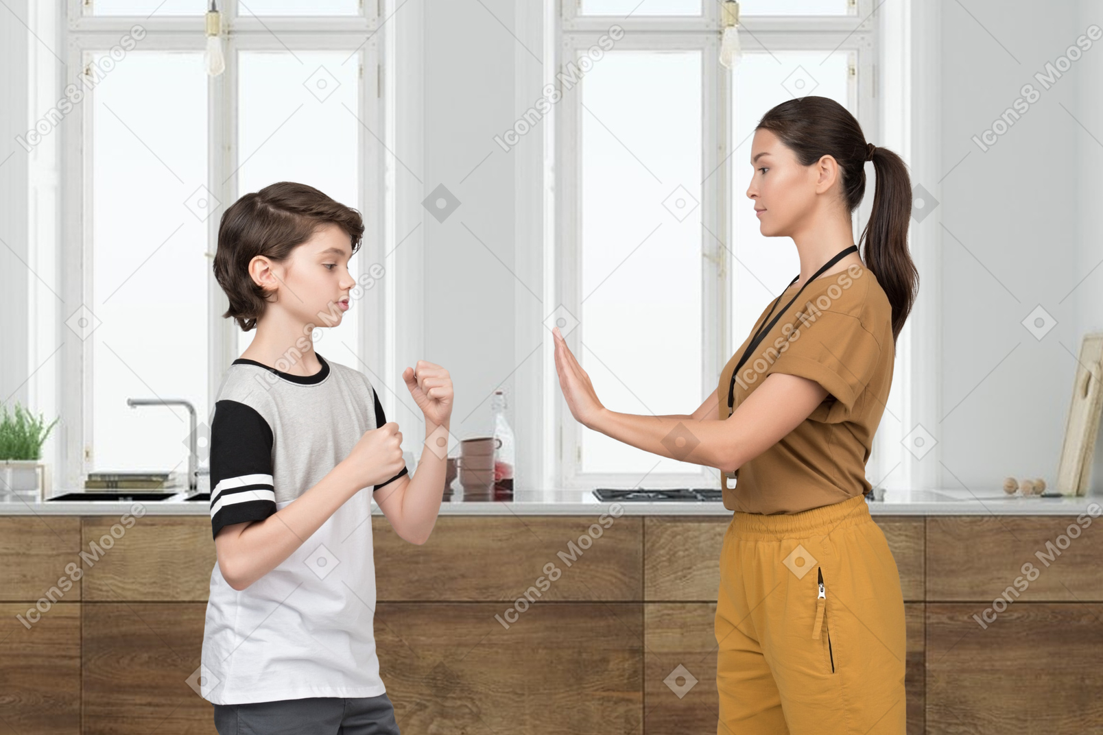 Female coach stopping a boy in a fighting position