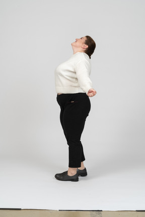 Happy plus size woman standing in profile
