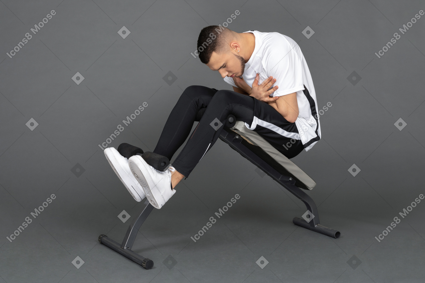 Young man doing abs on a bench