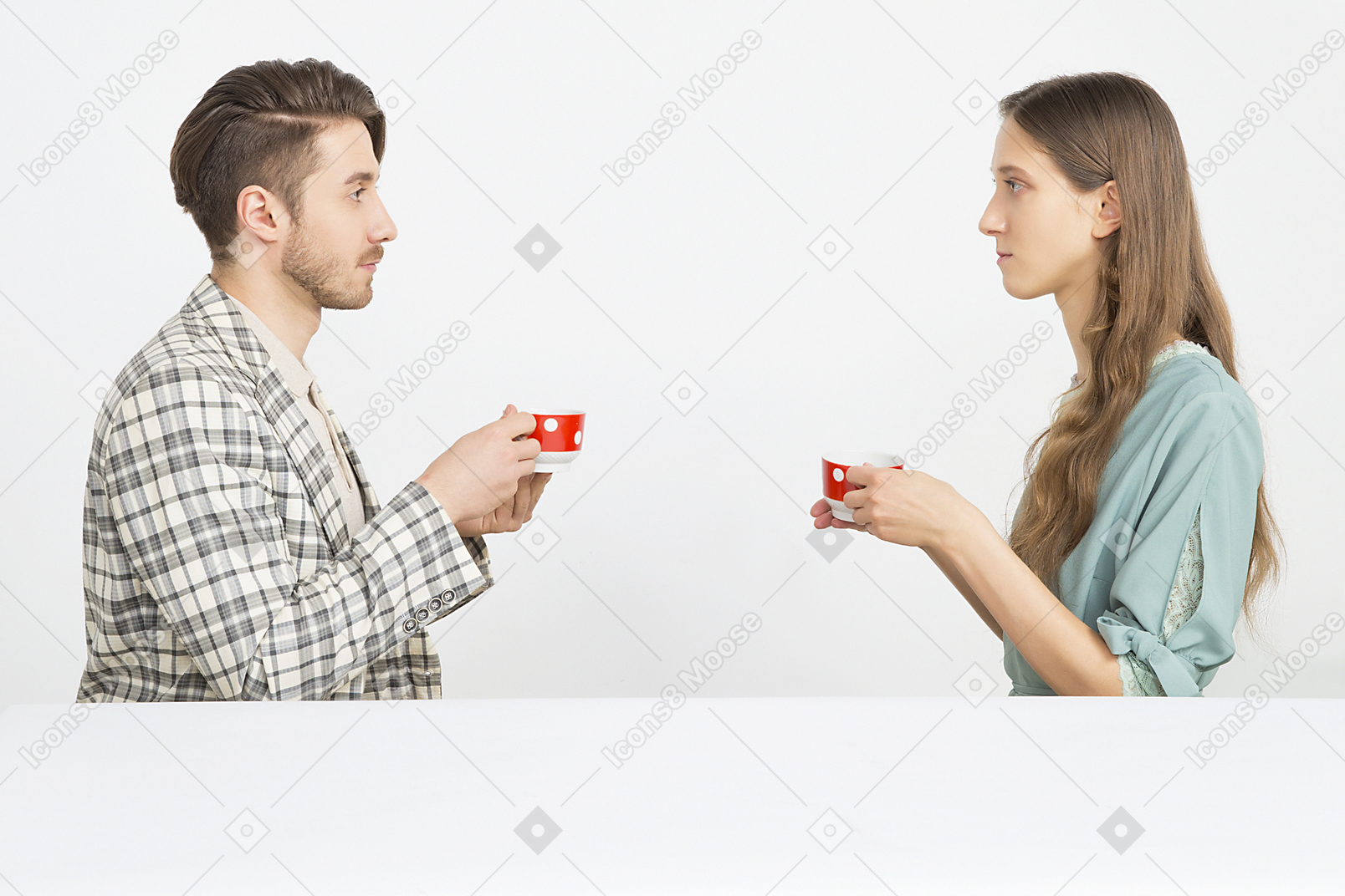 Couple having holding tea and sitting in pforile and looking at each other